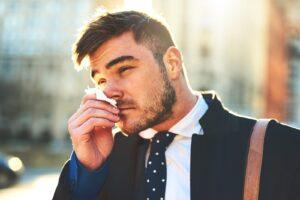 man-blowing-nose-on-tissue