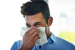 sick businessman in office with allergies and sinusitis
