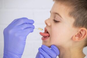 young child take sublingual immunotherapy
