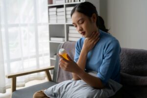 young-woman-holding-medication-bottle-and